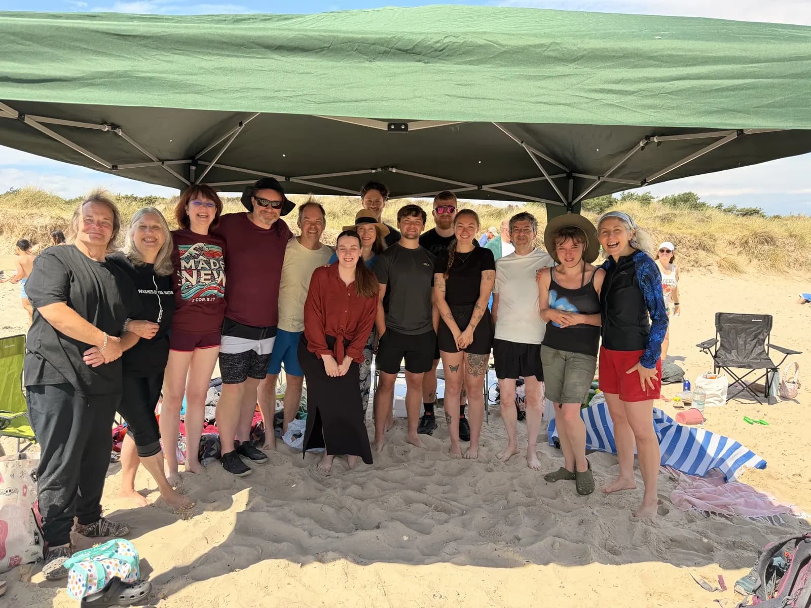 The Crowd Church group under a gazebo on the beach after the baptisms