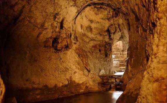 Inside Hezekiah's tunnel beneath Jerusalem, a rock-cut passage with water